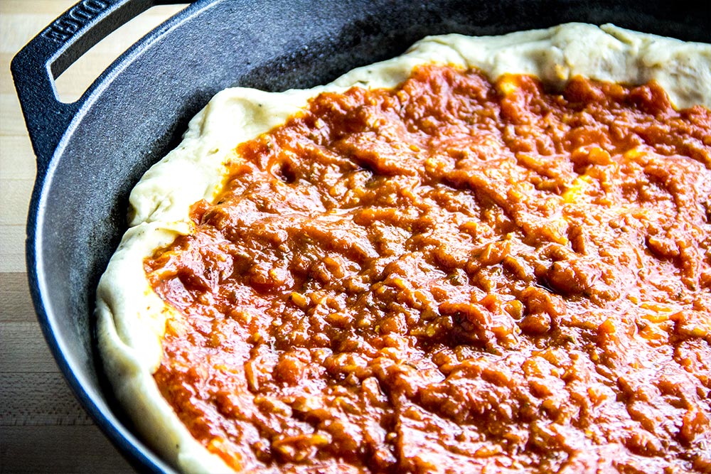 Adding Tomato Sauce to Pizza