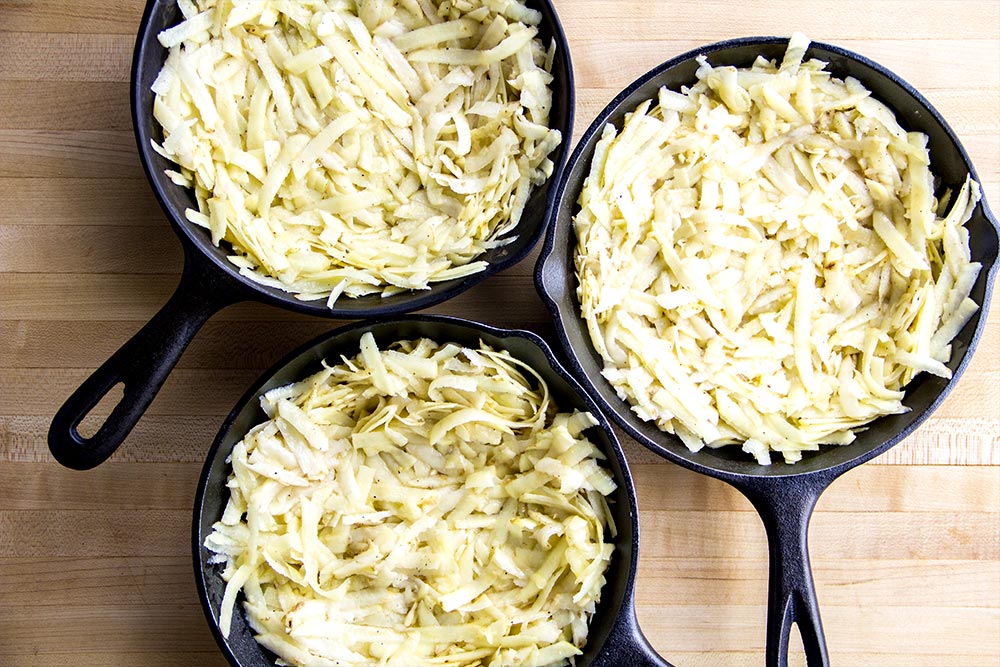 Shredded Potatoes in Cast Iron Skillets