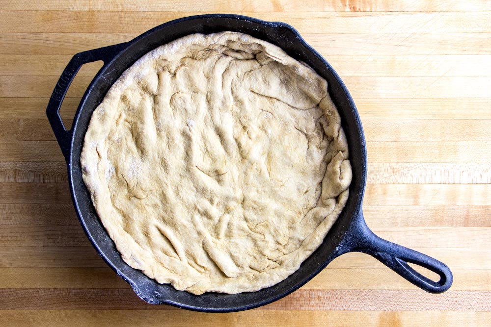 Raw Pizza Dough in Cast Iron Skillet