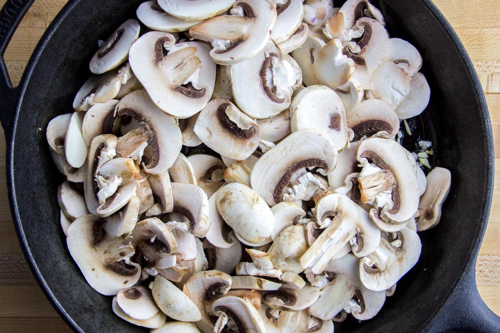 Sliced Mushrooms in Cast Iron Skillet