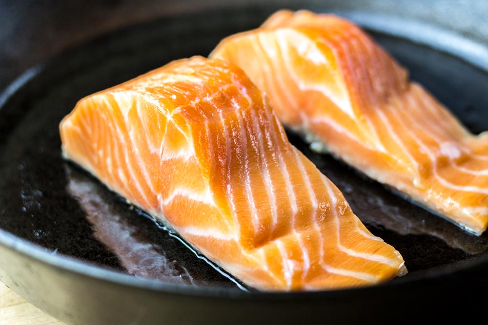 Raw Salmon Fillets in Cast Iron Skillet