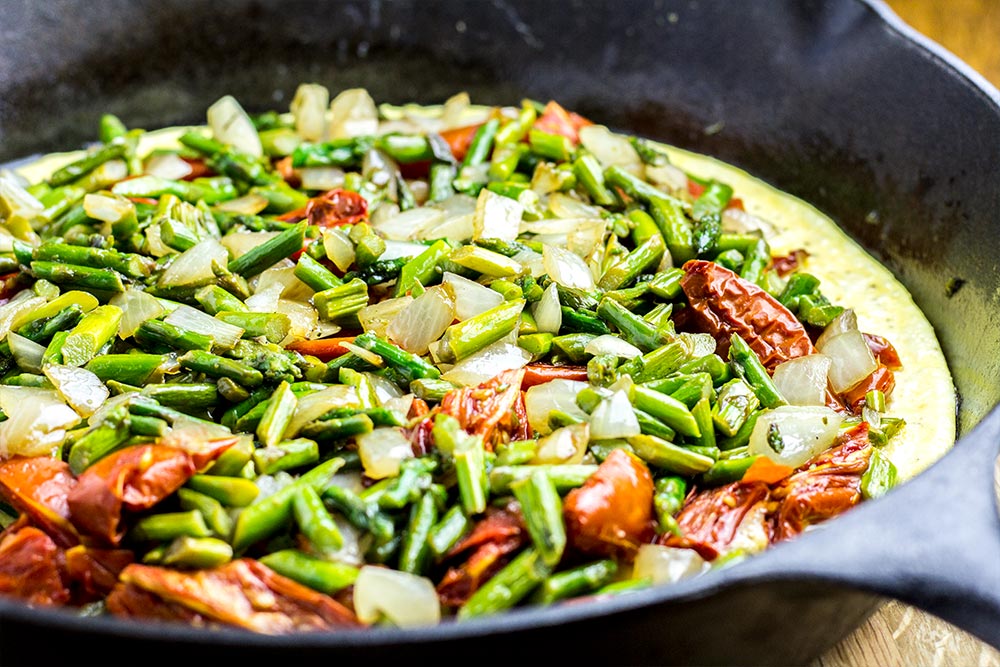Adding Asparagus & Onion to an Omelet in a Cast Iron Skillet
