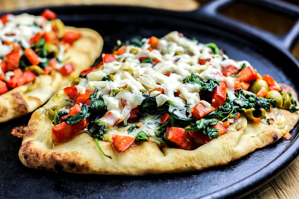 Naan Flatbread with Spinach, Olives, Tomatoes & Fontina Cheese