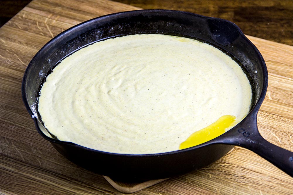 Raw Cornmeal Batter in Cast Iron Skillet