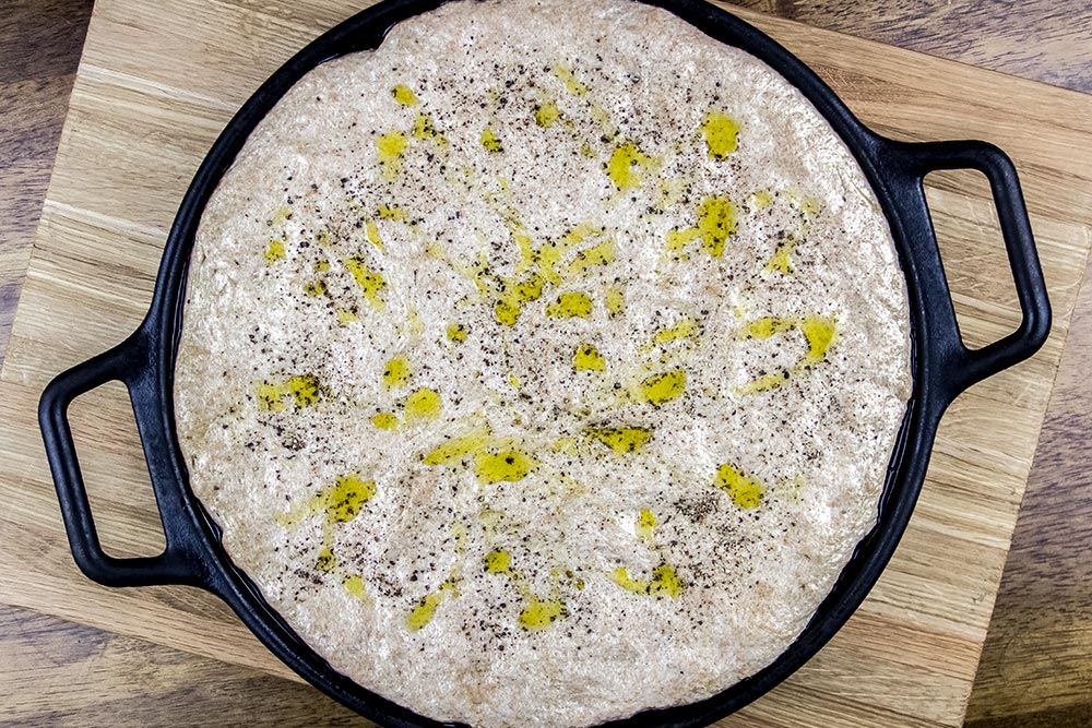 Adding Extra-Virgin Olive Oil and Ground Black Pepper to Pizza Dough