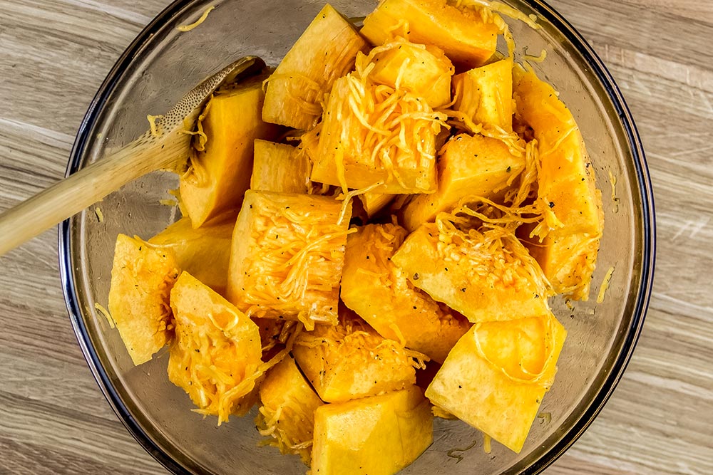 Pieces of Pumpkin Coated with Olive Oil in Bowl