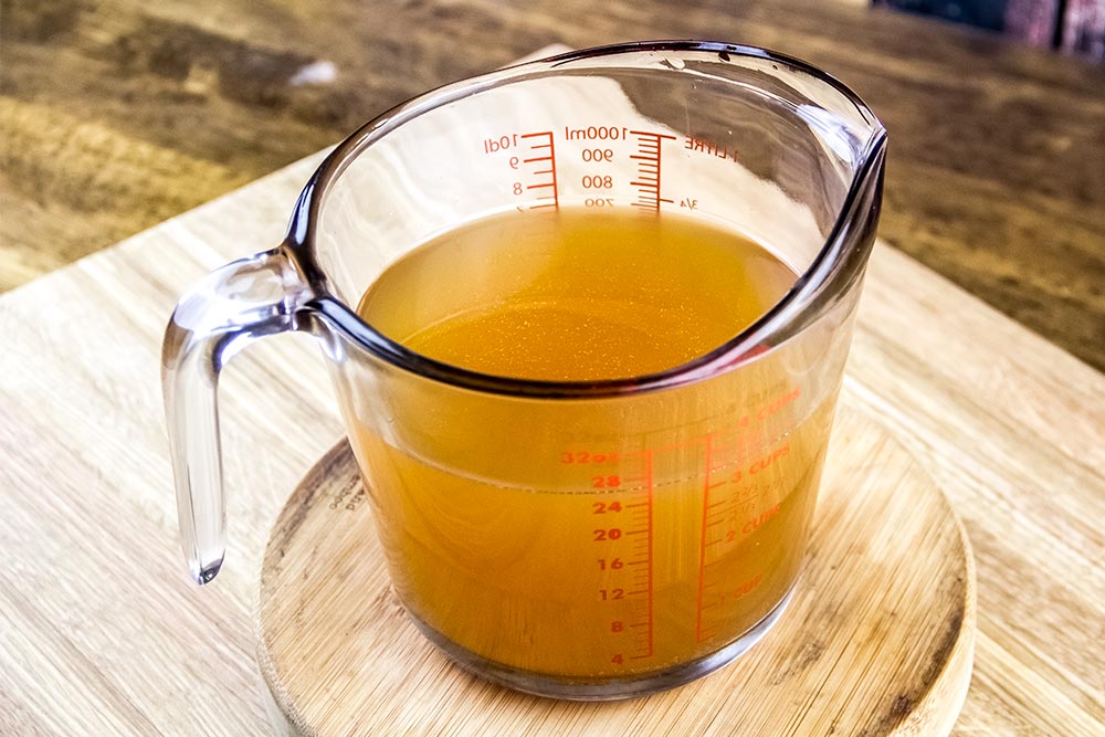 Vegetable Broth in Glass Measuring Cup