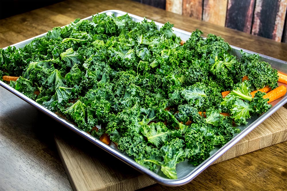 Kale Spread Over Carrots on Large Baking Sheet
