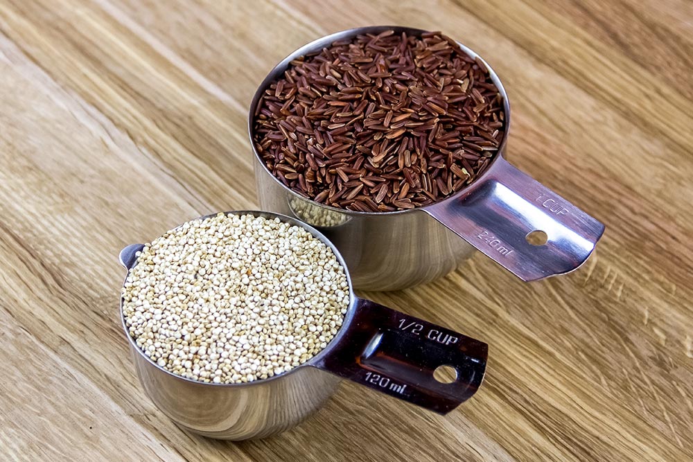 Red Rice and Quinoa in Stainless Steel Measuring Cups