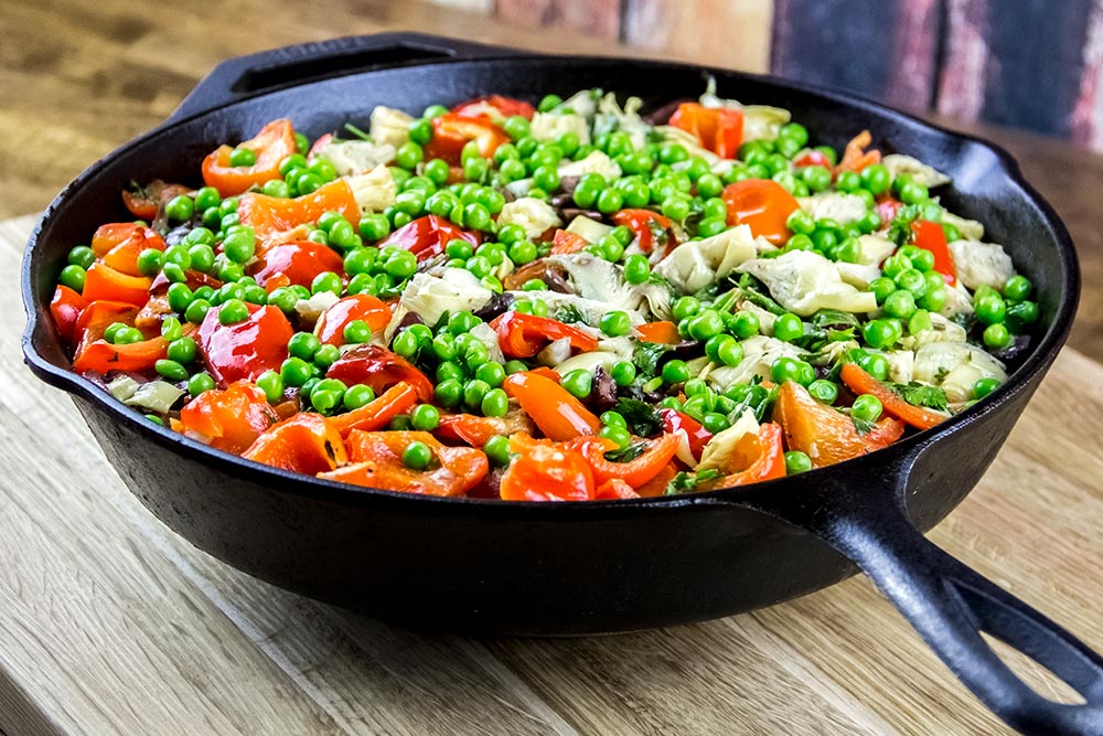 Adding Peas to Vegetable Mixture in Skillet