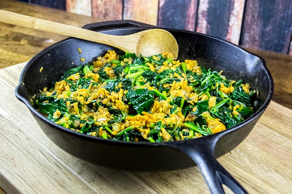 Adding Spinach to Other Ingredients in Skillet
