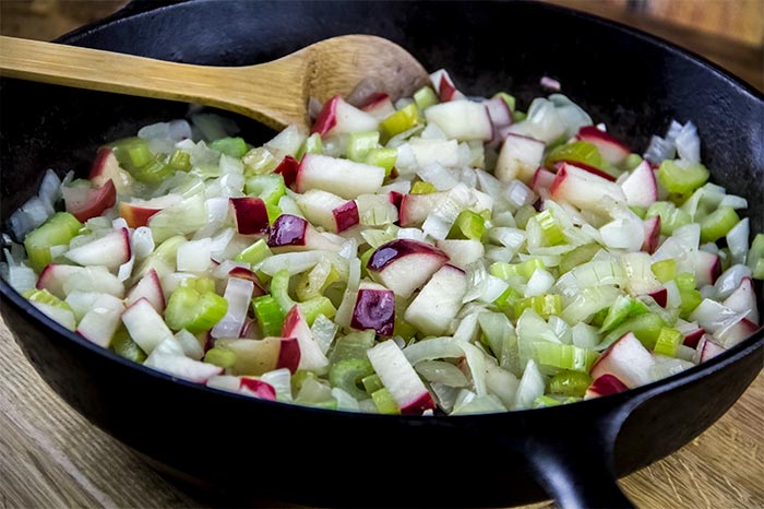Cooked Onion, Celery and Apples in Cast Iron Skillet