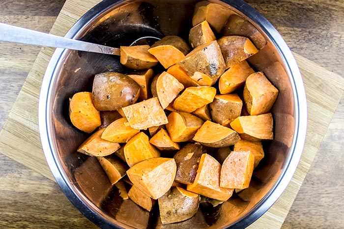 Mixing Sweet Potatoes with Olive Oil and Salt