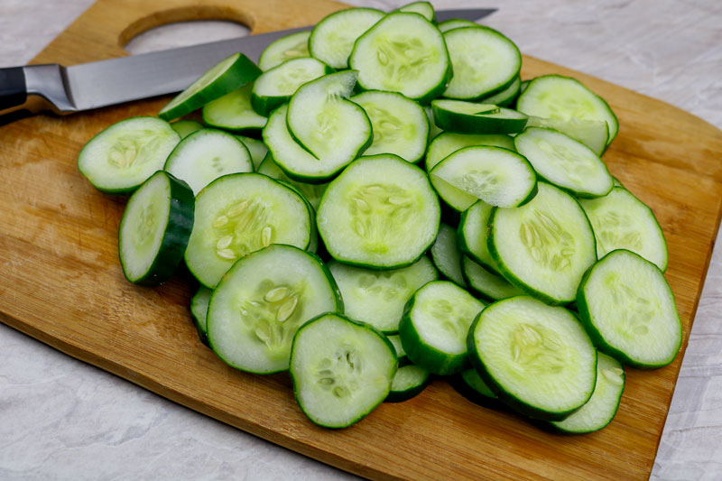 Sliced Cucumbers Set On A Cutting Board